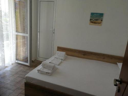 a bedroom with a bed with towels on it at Hris in Chernomorets