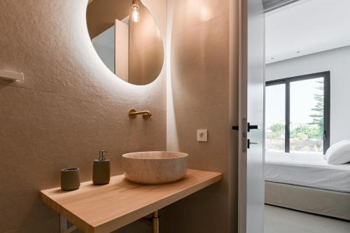 a bathroom with a sink and a mirror at Melior Luxury Villas in Mytikas