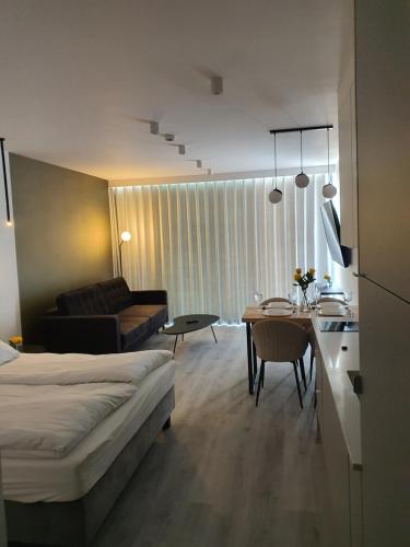 a bedroom with a bed and a living room at Sea & Lake Apartament 17, 317 Molo Mielno Sosnowy Las 15 in Mielno