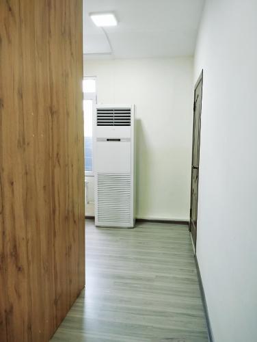 an empty hallway with an air conditioner in a room at Salma Capsule Hostel in Bishkek