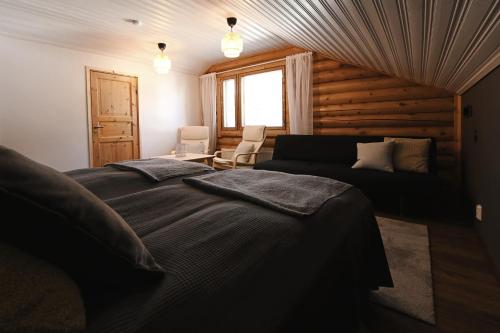 a living room with a bed and a couch at Levillenet Bearlodge at Levi city centre in Levi