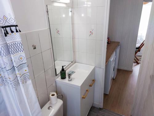 a white bathroom with a sink and a toilet at Le Sympathique in Rouen