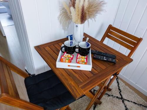a table with a tray of food and a remote control at Le Sympathique in Rouen