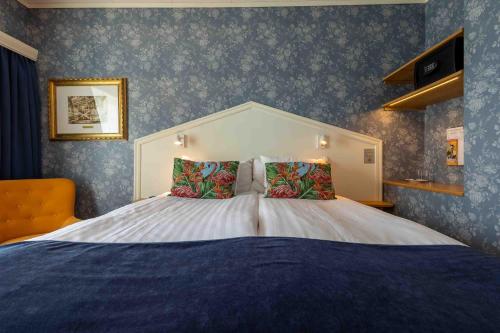 a bedroom with a large bed with blue wallpaper at Säröhus Hotel, Conference & Spa in Särö