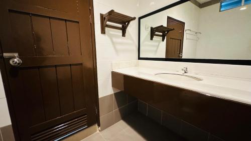 a bathroom with a sink and a mirror at TC Garden Resort in Kuah