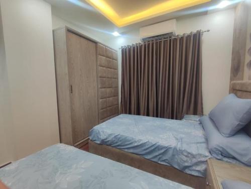 a small bedroom with two beds and a window at Oznel Studio in Qadd el-Barûd