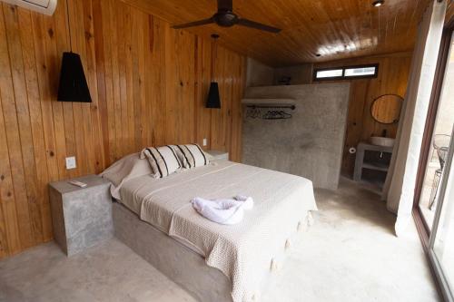 a bedroom with a bed with a towel on it at Naari Cabañas Boutique in Brisas de Zicatela