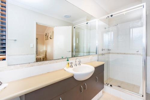 a bathroom with a sink and a shower at Coode Street Townhouse in Perth