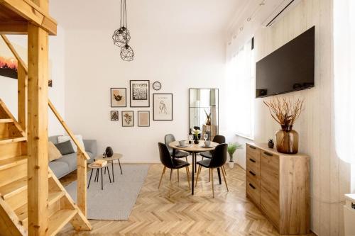 a white living room with a table and chairs at Balint Budapest Apartment next to Synagogue, best location in city center in Budapest