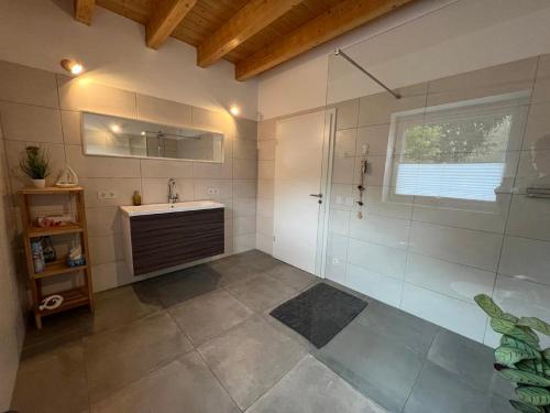 a bathroom with a shower and a sink at Schwarze Eule Ferienwohnung in Beckingen