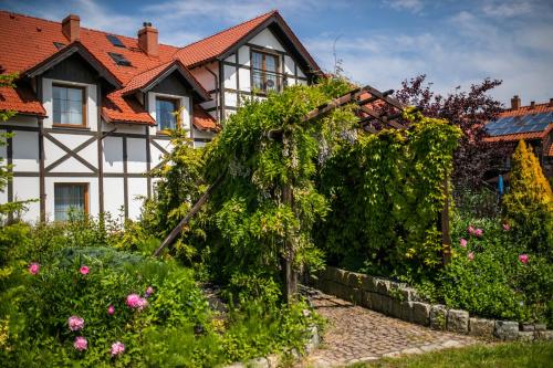 a house with a garden in front of it at Nordowi Dwór in Celbowo