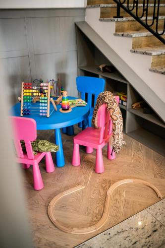 a room with a table and chairs and stairs at Nordowi Dwór in Celbowo