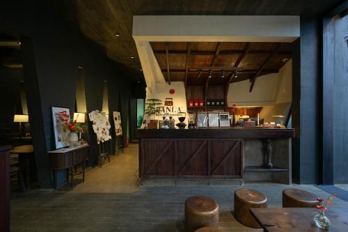 a restaurant with a bar and stools in a room at Banla Boutique Hotel in Da Lat