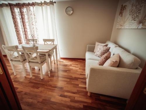 a living room with a white couch and a table at LA TERRAZZA DEI GEMELLI - casa vacanze in Venosa
