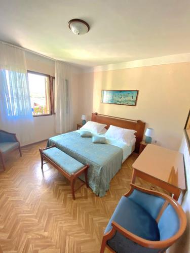 a bedroom with a bed and a table and a chair at Olive Garden in Posedarje