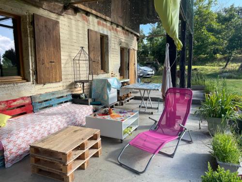 eine Terrasse mit einem Tisch, einem Tisch und Stühlen in der Unterkunft L'écrin - Chambres d'hôtes au calme et au vert in Sainte-Gemme-Martaillac