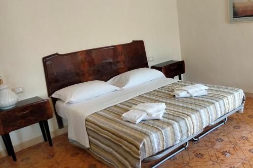 a bedroom with a bed with two towels on it at ATTICO SULLA BOUGANVILLE (Albergo diffuso) in Corinaldo