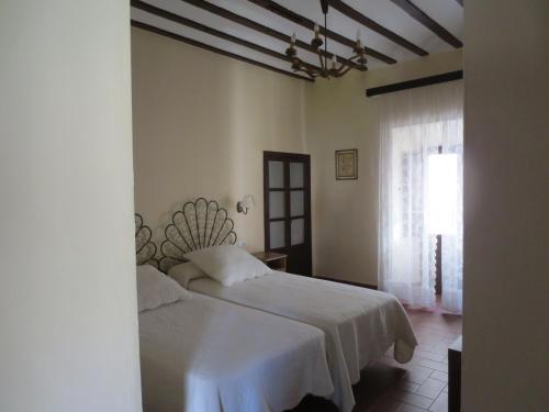 Una cama o camas en una habitación de Apartamentos Turísticos El Losal