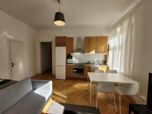 a living room with a table and a kitchen at Home Inn VMG in Stockholm
