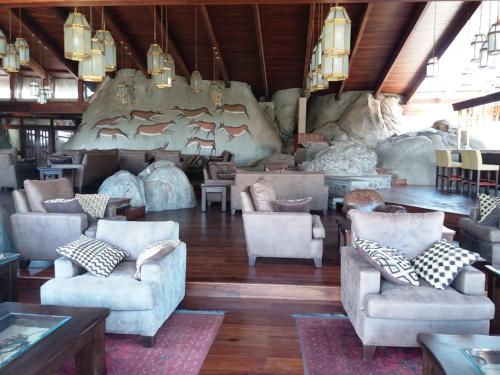 a large room with couches and chairs in a building at Seronera Wildlife Lodge in Serengeti National Park
