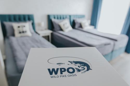 a table with a wroo sign on it next to two beds at WPO - WILD PIKE OASIS in Caraorman