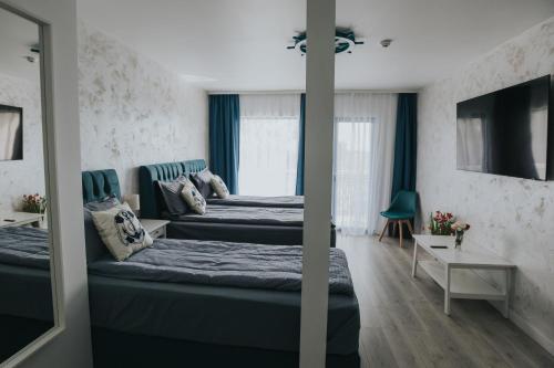a hotel room with two beds and a television at WPO - WILD PIKE OASIS in Caraorman