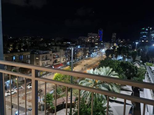 a view of a city at night from a balcony at Best Place to relax in Tel Aviv in Tel Aviv