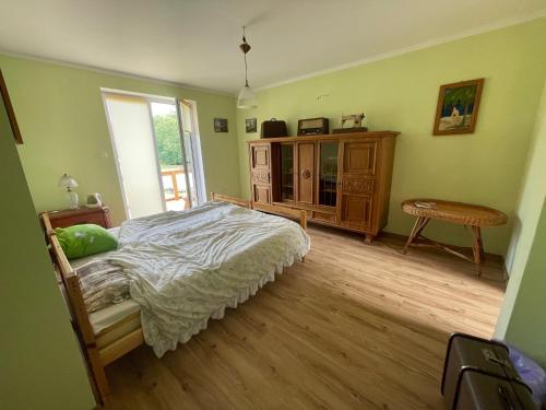 a bedroom with a bed and a wooden floor at Kopice " Kowalczyk Hotel Residences In Nature Parks " in Gollnow