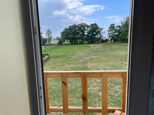 a view of a field from a window at Kopice " Kowalczyk In Nature Parks Blue Velo" in Gollnow