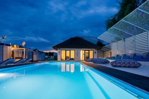 a swimming pool at night with a house at WPO - WILD PIKE OASIS in Caraorman