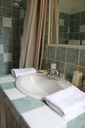 a bathroom with a white sink and a mirror at Bastide Saint Bernard in Le Thoronet