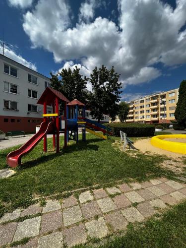 a playground with a slide in a park at Apartmán Lúčky Bojnice in Bojnice