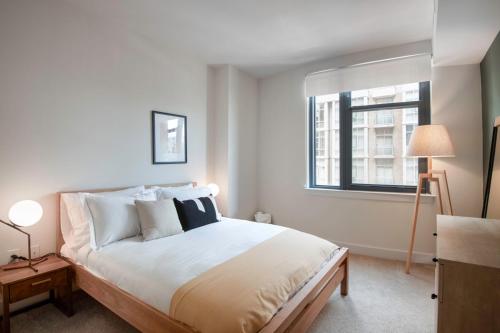 a bedroom with a large bed and a window at Mt Vernon 1BR w Gym WD 2 Pools roomy rooftop WDC-39 in Washington, D.C.