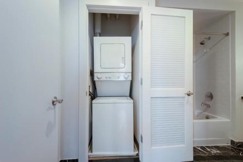 a white refrigerator in a bathroom with a shower at Mt Vernon 1BR w Gym WD 2 Pools roomy rooftop WDC-39 in Washington, D.C.