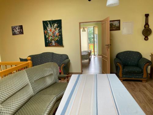 a living room with a couch and two chairs at Kopice " Kowalczyk In Nature Parks Blue Velo" in Gollnow