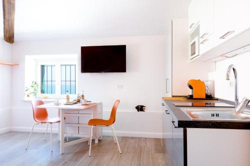 a kitchen with a table and chairs and a sink at Villa Bice in Bergeggi