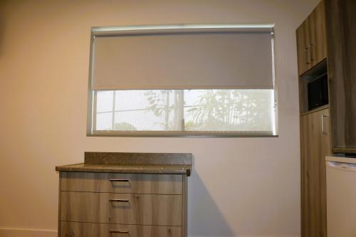 a window with a roller blind in a kitchen at Childers Oasis Motel in Childers