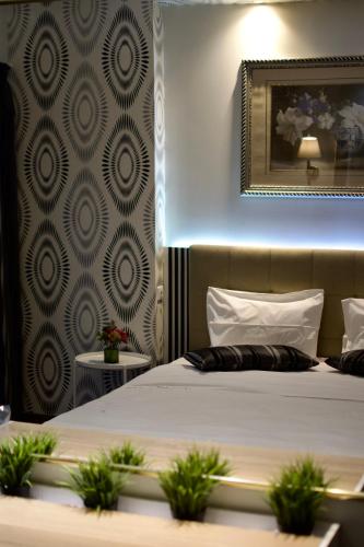 a bedroom with a bed and a mirror on the wall at Minoa Athens Hotel in Athens