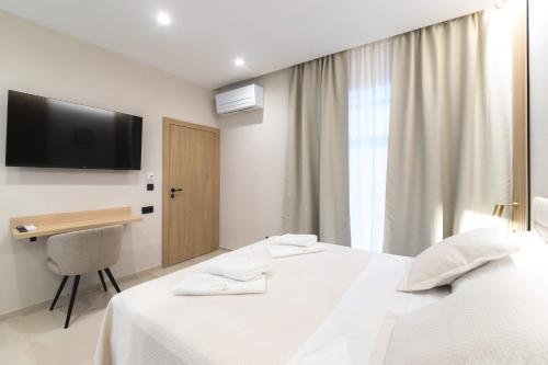 Ένα ή περισσότερα κρεβάτια σε δωμάτιο στο Tonio Rooms