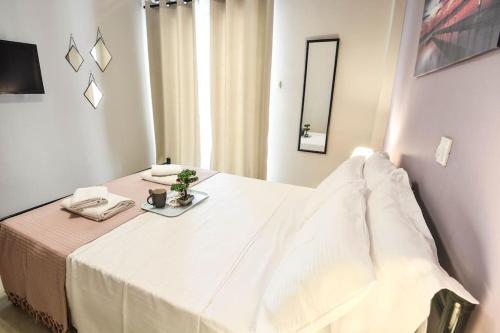 a room with a bed with a table with a mirror at Central Apartment in Xylokastron