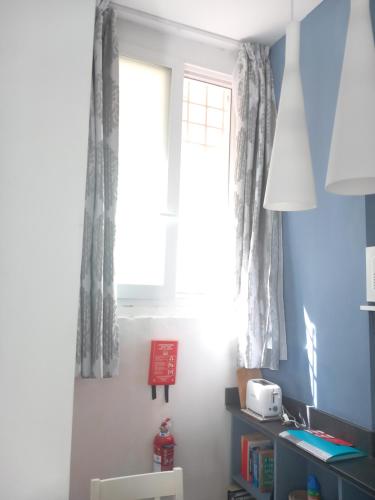 a window in a room with a table and a chair at Door Eight in Il-Furjana