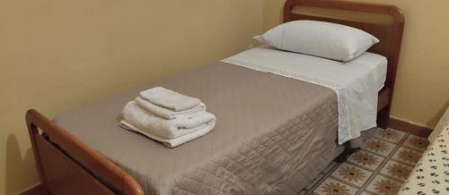 two towels are stacked on a bed in a room at Residenza dal Barone in Paestum