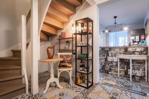 a room with a table and a stool and a sink at Hotel TWEED in Sankt Peter-Ording