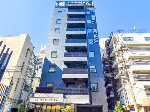 a tall building with a sign on top of it at HOTEL LiVEMAX Akasaka GRANDE in Tokyo