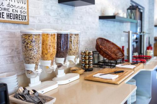 a counter with a bunch of different types of food at Zenitude Swiss Apparthotels in Ferney-Voltaire