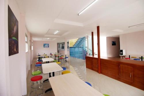 a classroom with tables and chairs in a classroom at The Aurora by Makati in Lembang