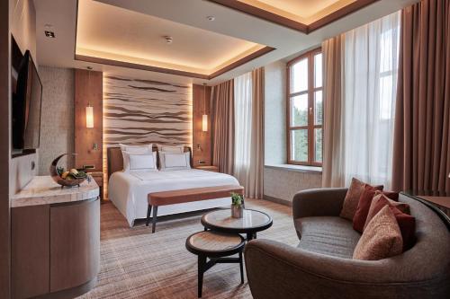 a hotel room with a bed and a couch at Swissotel Uludag Bursa in Bursa