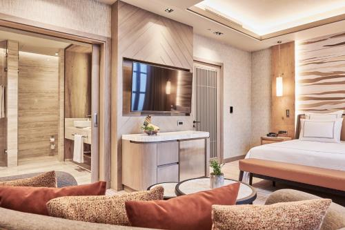 a hotel room with a bed and a bathroom at Swissotel Uludag Bursa in Bursa