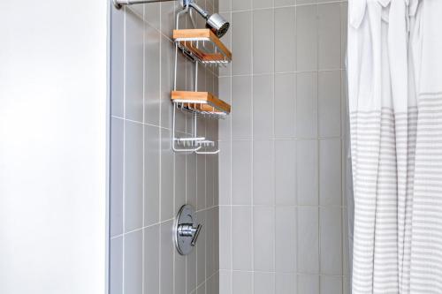 a bathroom with a shower with a shower head at E Cambridge studio w WD Gym steps from Train BOS-522 in Boston