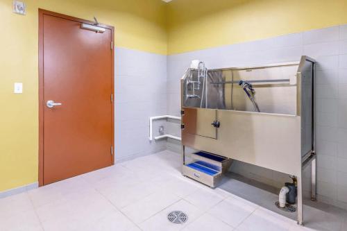 a bathroom with a shower stall and a brown door at Kendall Sq 2BR w Gym nr MIT Mass General BOS-665 in Boston